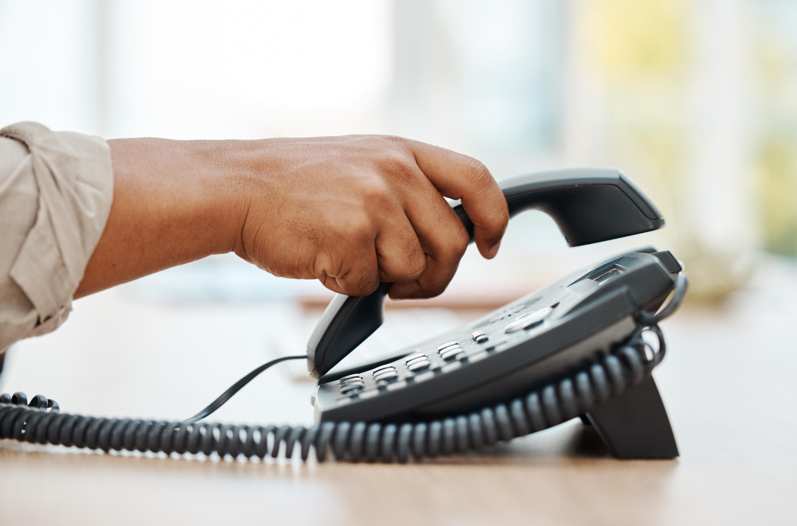 Virtual receptionist or automated answering service: hand holding phone