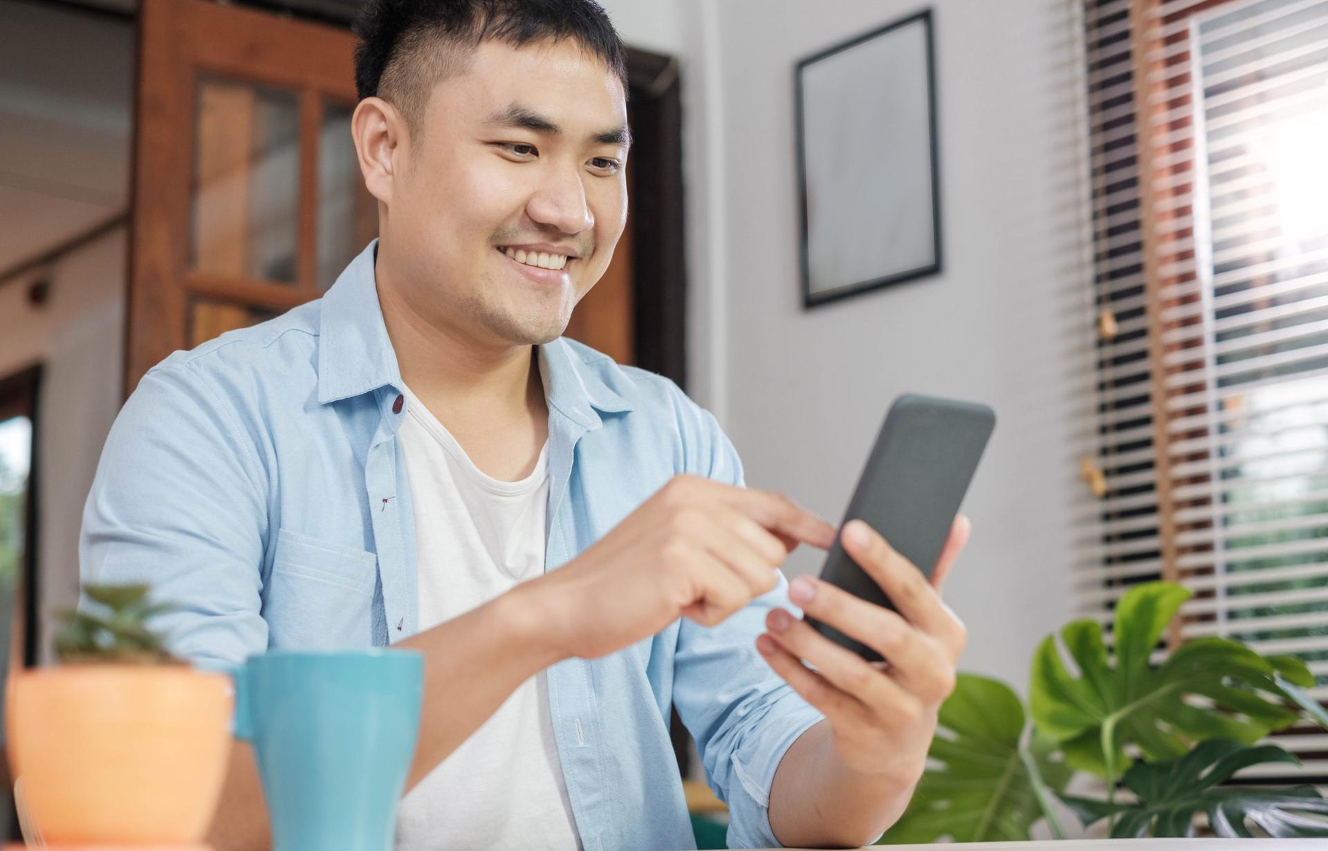 Up to date with evolving customer expectations: Customer smiles while using phone