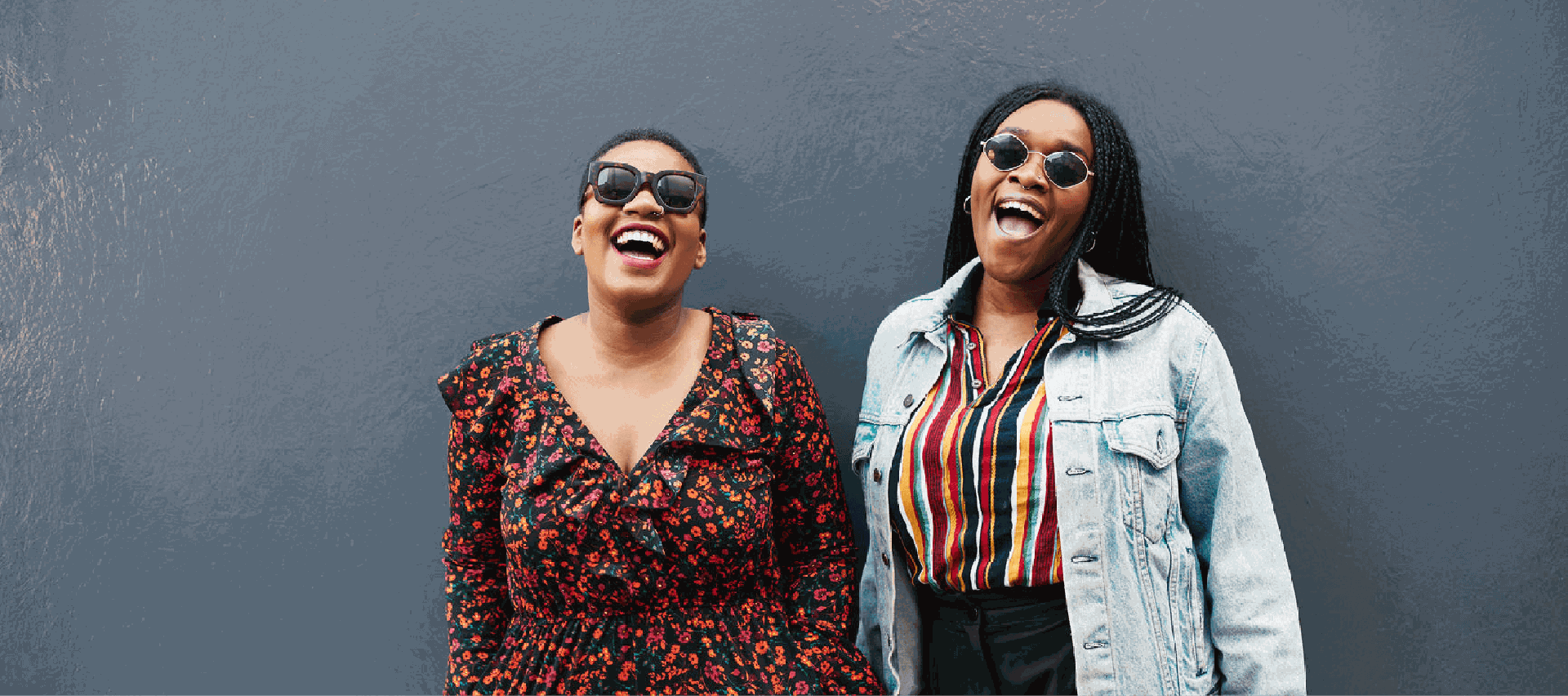 Two smiling women wearing sunglasses