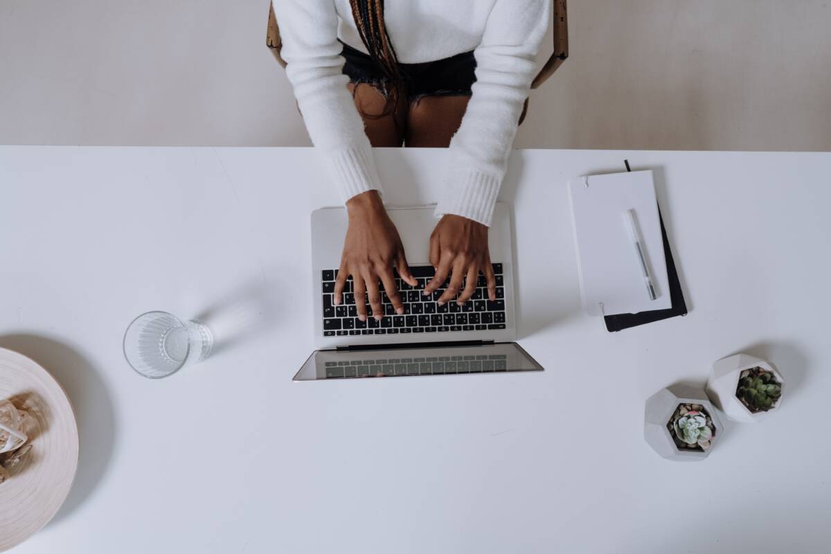 Overhead view of a woman typing at desk