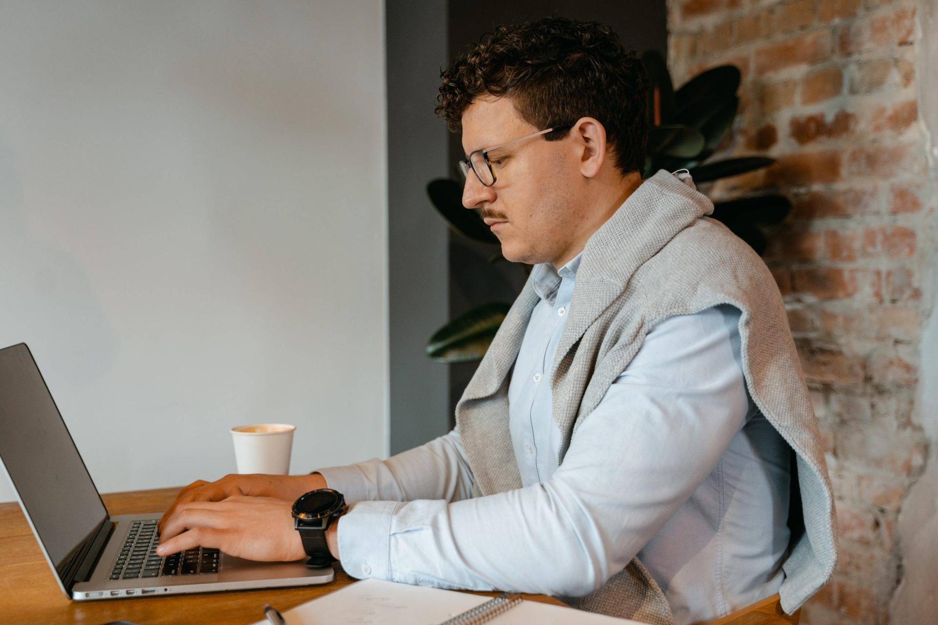 Fashionable man working on a laptop