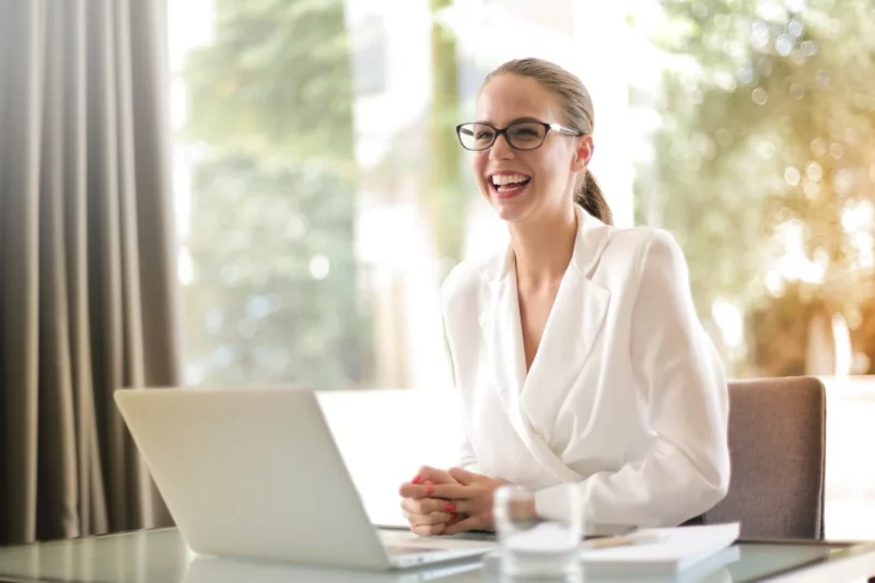 Ruby and MyCase: attorney smiling while using laptop at desk