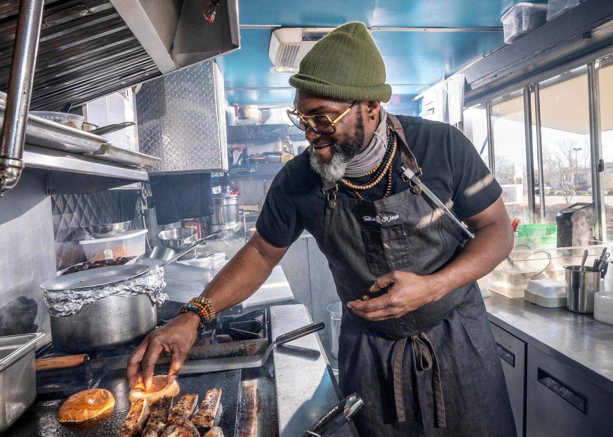 3 most common SBA loans: a man cooks food on a stove