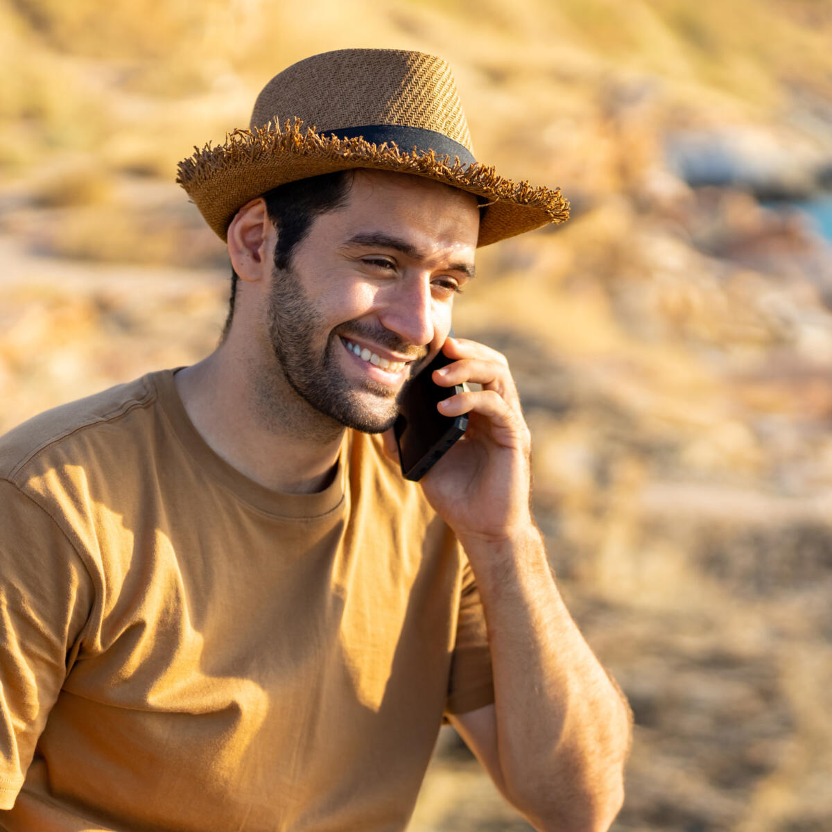 Man smiling using phone