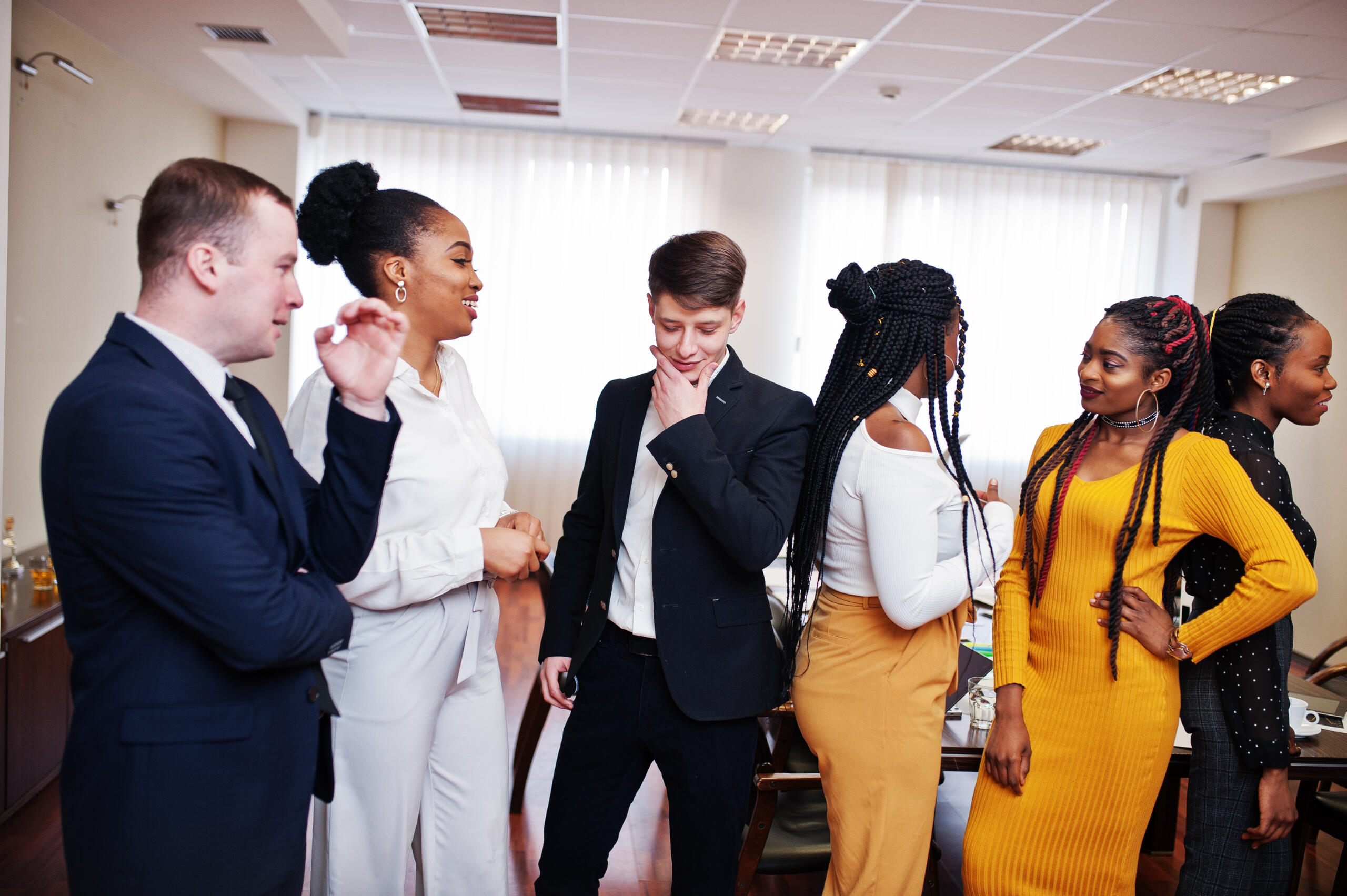 How to make small talk: a group of people gather around in an office having a conversation