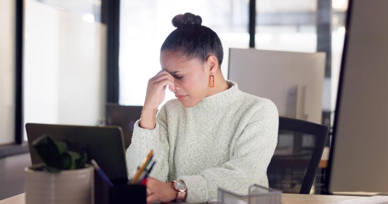 Front desk burnout: reeceptionist looks sad and stressed out at desk