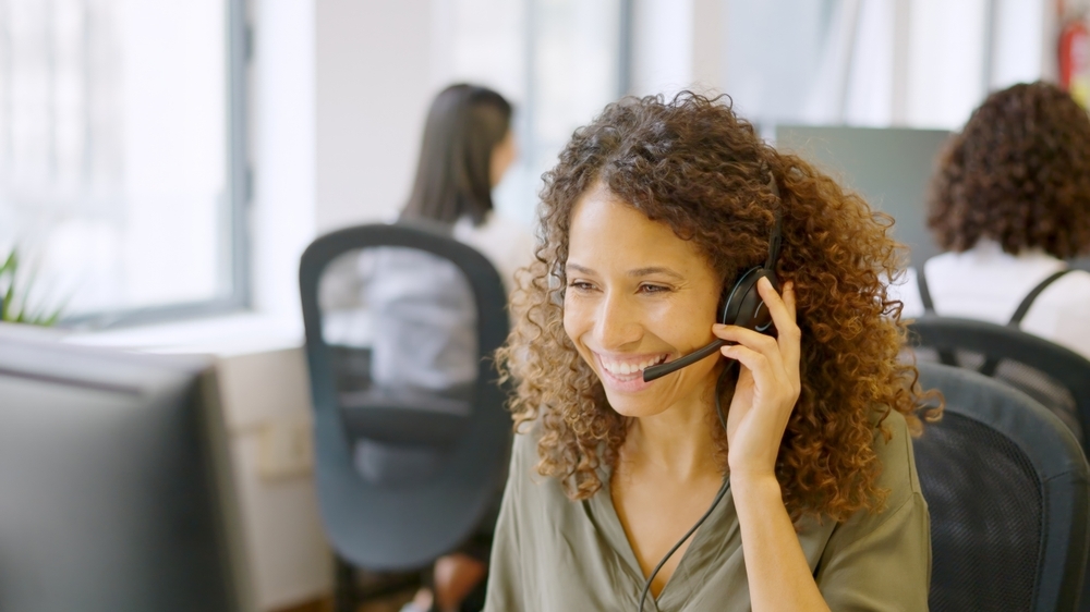 woman wearing headset taking a call in an office