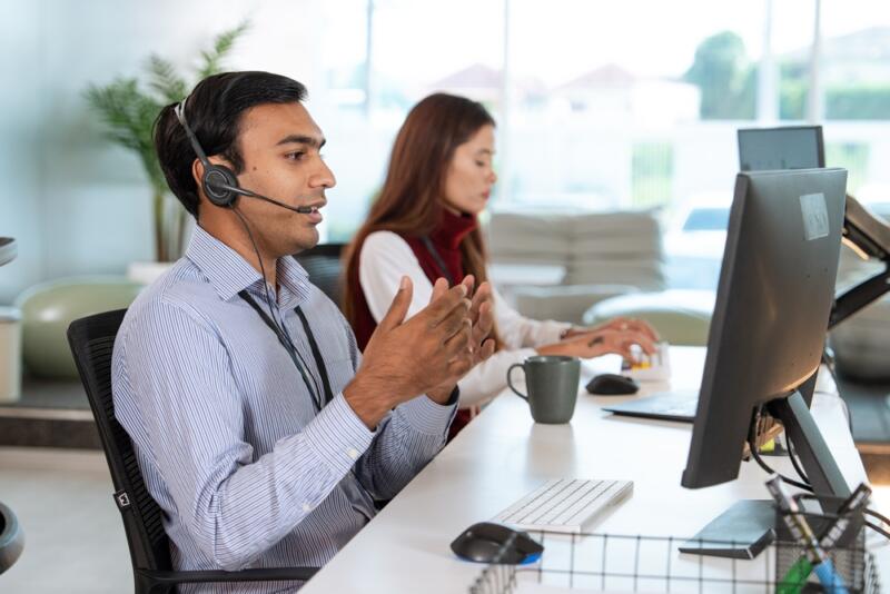 male virtual receptionist in striped shirt on a call