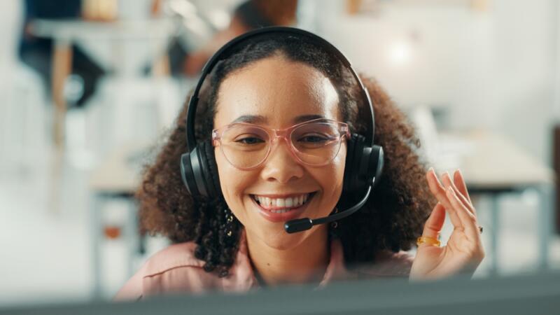 virtual receptionist smiling while working