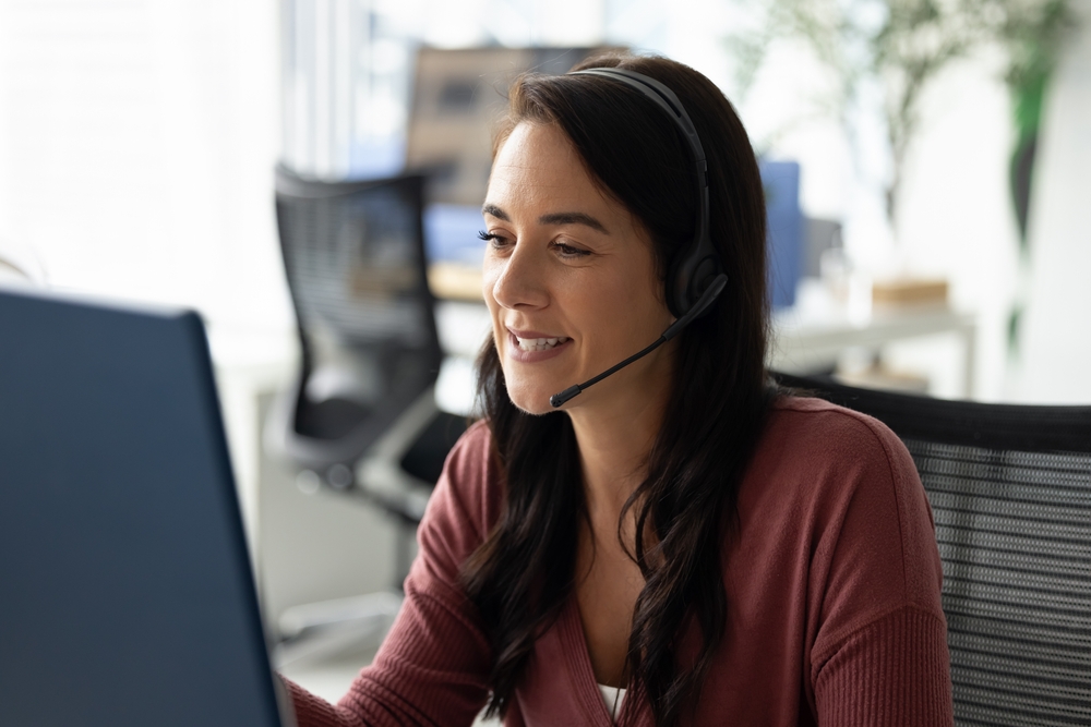 female virtual receptionist on a call sitting in an office chair
