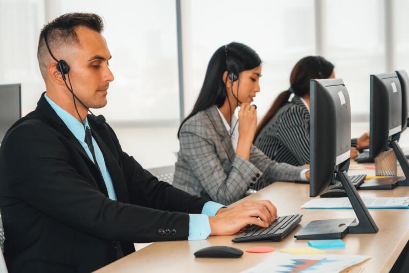 law firm virtual receptionist team working at a shared desk