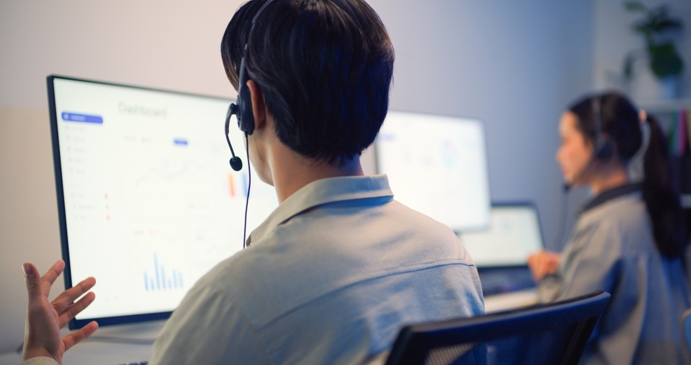 virtual receptionist team working at a shared desk