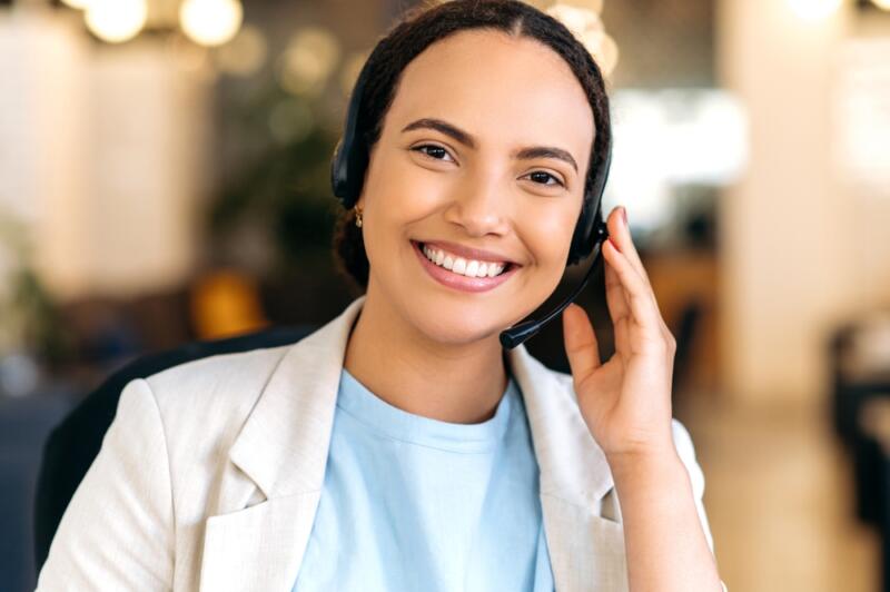 female virtual receptionist wearing a blue shirt smiling at camera