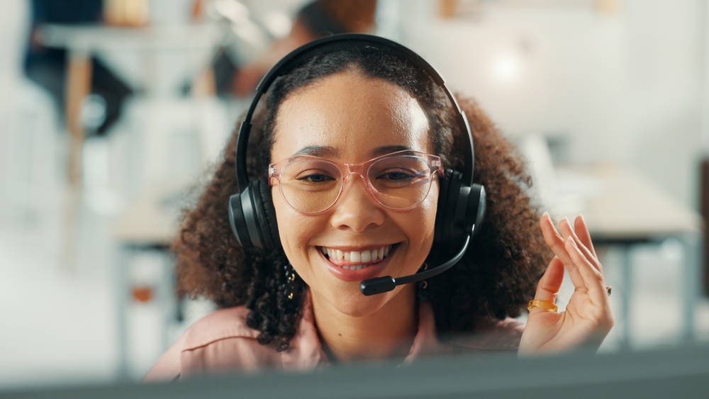 smiling female virtual receptionist with glasses
