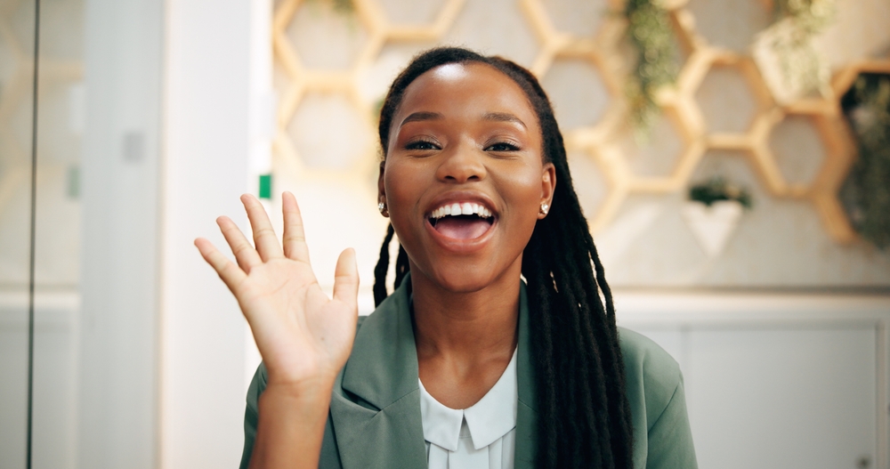 female virtual receptionist waving at camera