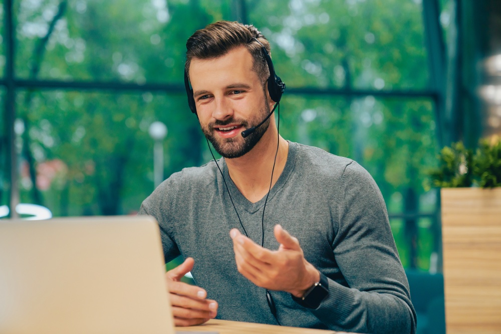 male virtual receptionist on call wearing a headset